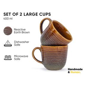 Set of 2 large brown ceramic cups with text on a white background