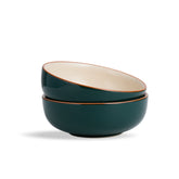 Two green ceramic bowls stacked on a white background