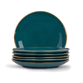 Set of four teal plates with gold rims on a white background