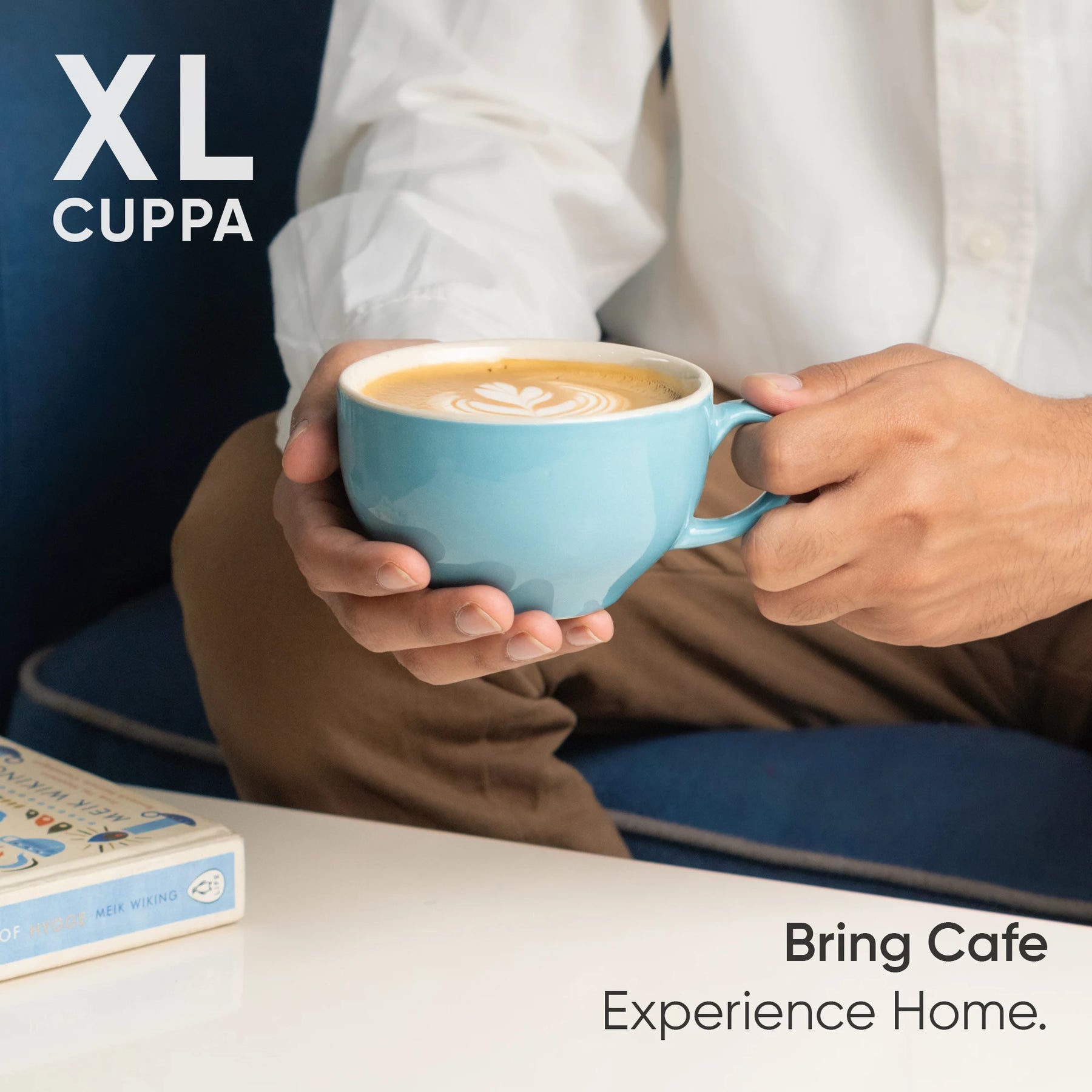 Person holding a blue mug of coffee with 'XL Cuppa' branding and text 'Bring Cafe Experience Home'.