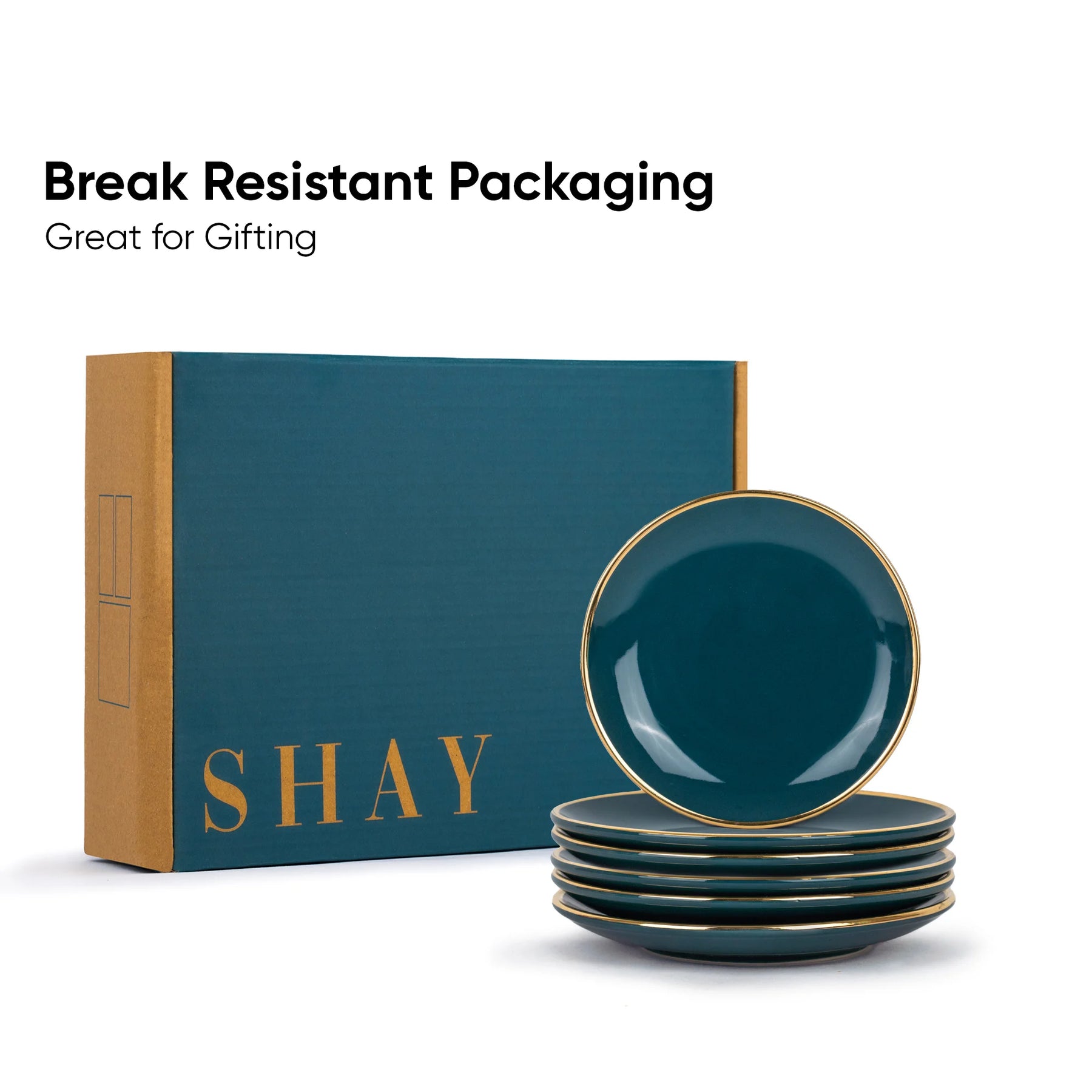 Set of green ceramic plates with gold rims in front of a 'SHAY' branded box on a white background.