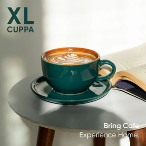 Teal coffee cup with latte art on a saucer, next to an open book, with 'XL Cuppa' branding.