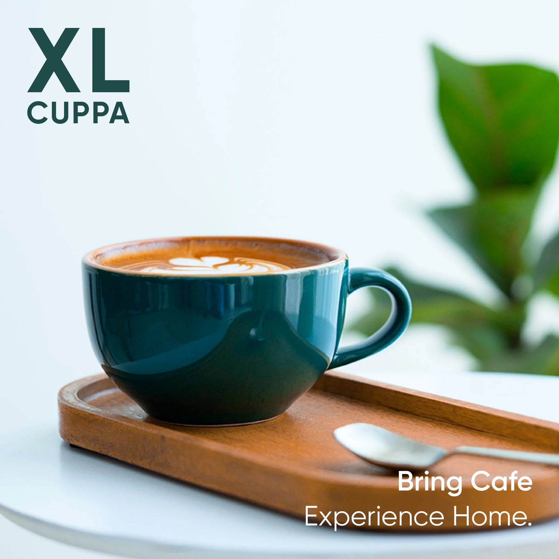Teal mug with coffee on a wooden tray, blurred plant in the background, 'XL Cuppa' branding.