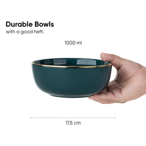 Hand holding a dark blue bowl with gold rim, labeled as durable and having a good heft, on a white background.