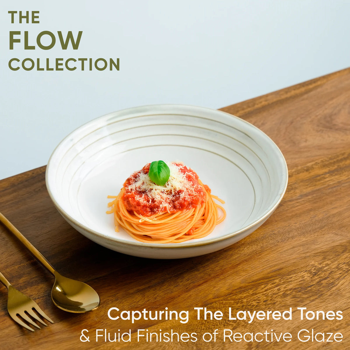 White bowl with spaghetti on a wooden surface, featuring 'The Flow Collection' text.