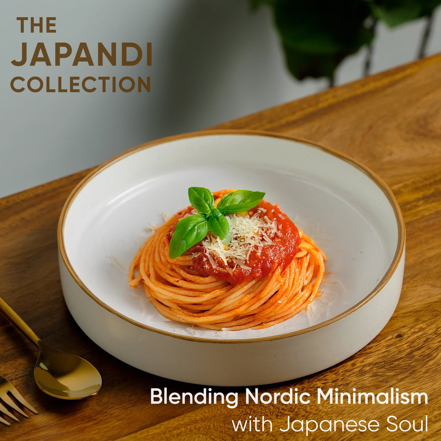 Bowl of spaghetti with tomato sauce and basil on a wooden table, featuring 'The Japandi Collection' text.