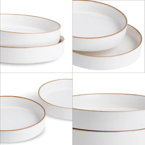 Set of white plates with gold rims arranged in a grid on a white background