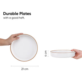White ceramic plates held by hands with measurements on a white background