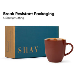 Brown mug with 'SHAY' branded box on a white background