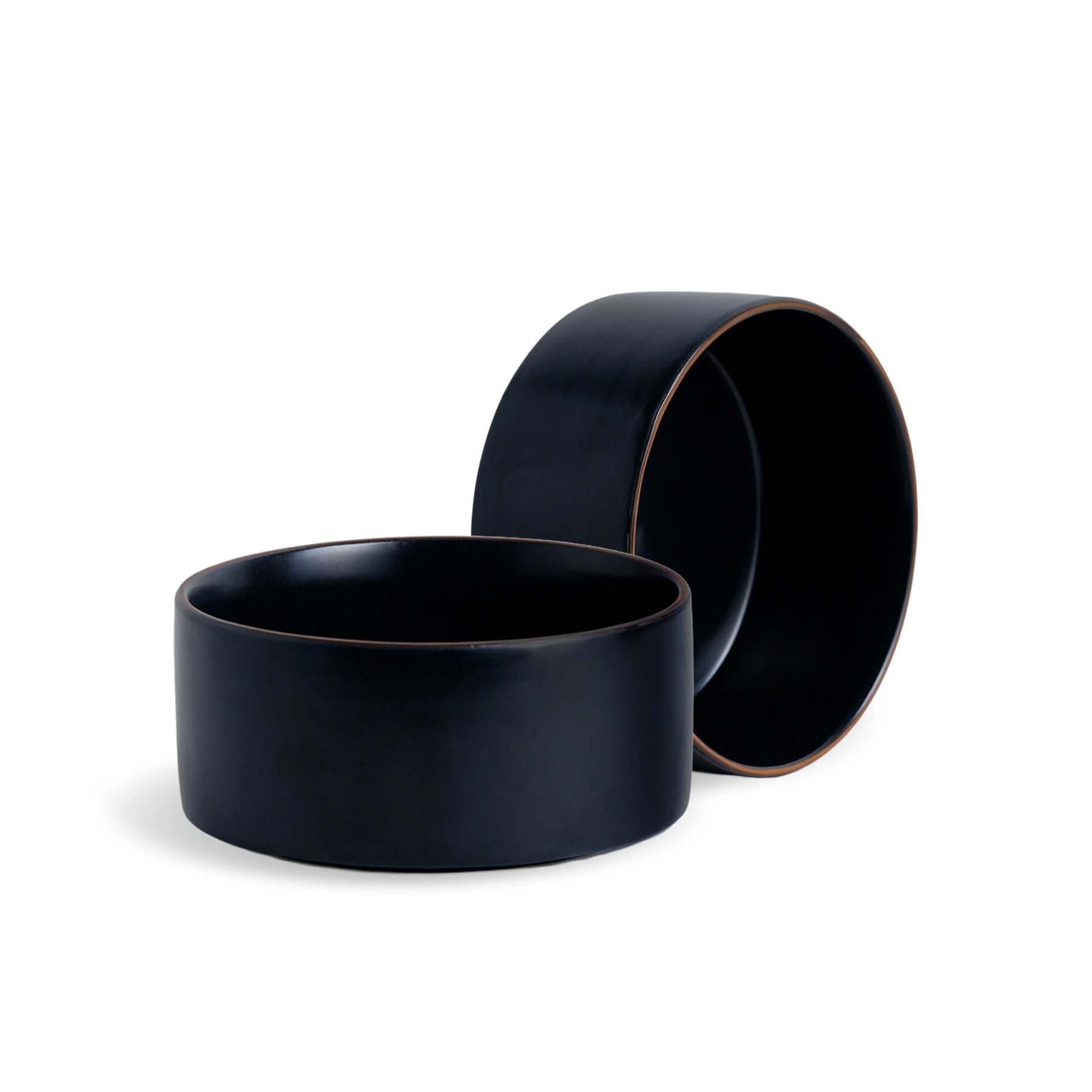 Two black ceramic bowls on a white background