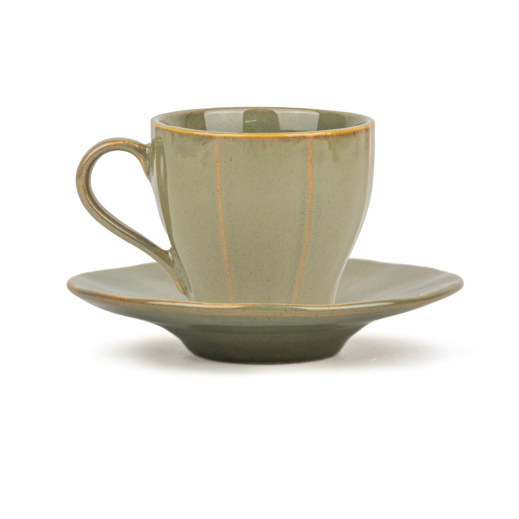 Green ceramic cup and saucer set on a white background
