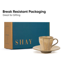 Ceramic cup and saucer with 'SHAY' branded box on a white background