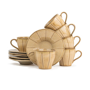 Set of beige ceramic dinnerware including cups and plates on a white background