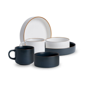 Ceramic dinnerware set with blue and white pieces on a white background