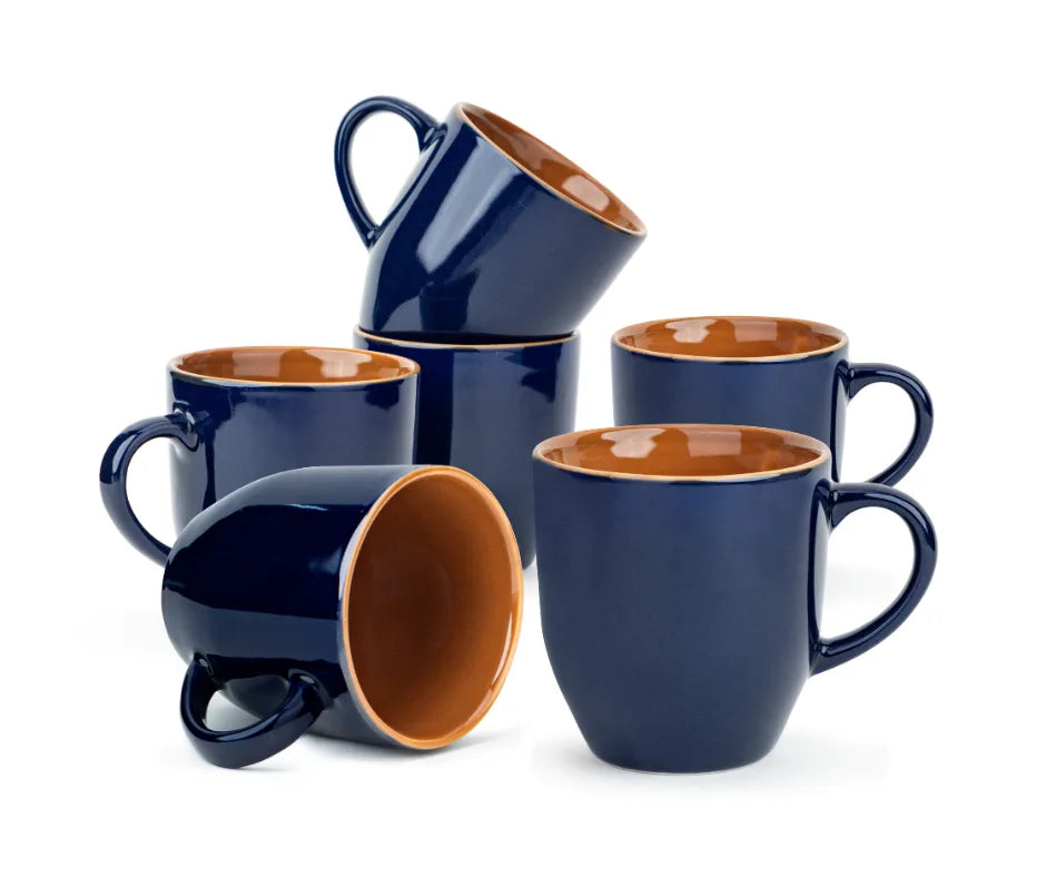 Set of blue mugs with brown interior on a white background