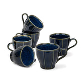 Set of six blue ceramic mugs on a white background