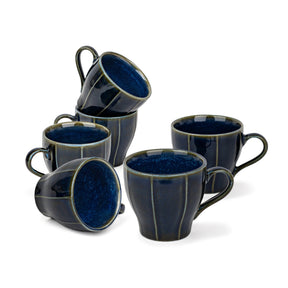 Set of six blue ceramic mugs on a white background