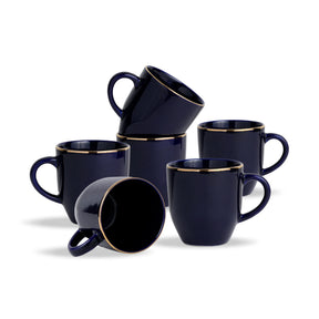 Set of six navy blue mugs with gold rims on a white background