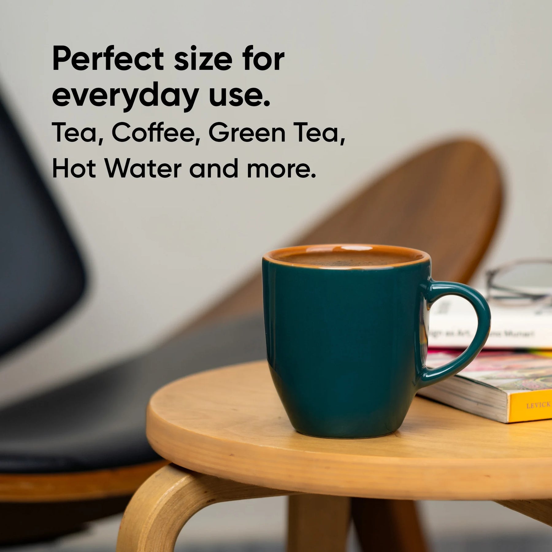 Teal mug on a wooden table with text about its versatility for various beverages.