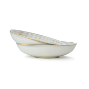 Two white ceramic bowls with gold rims on a white background